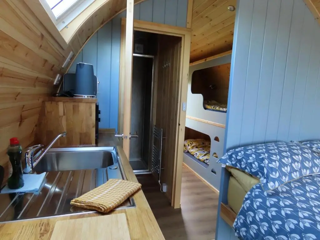 a bathroom with a sink in a tiny house at Luxury Pod 3 in Bonar Bridge