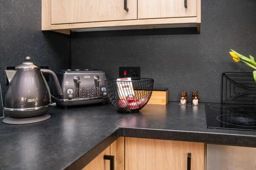 a kitchen counter top with a toaster and a blender at Highland Cow Apartment in Inverness