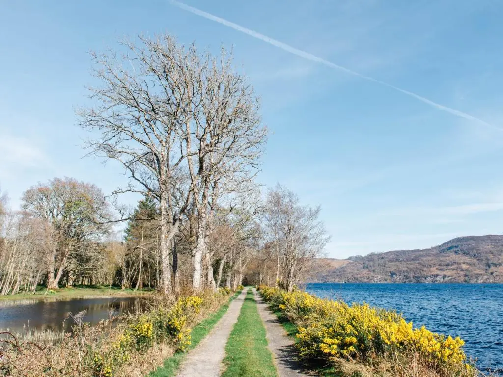 a dirt road next to a body of water at Holiday Home Farmburn by Interhome in Invermoriston