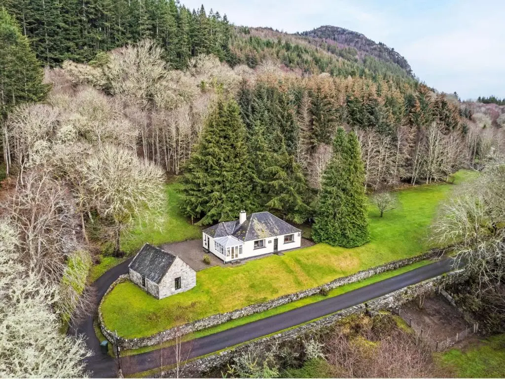 an aerial view of a white house on a green yard at Holiday Home Farmburn Bothy by Interhome in Invermoriston