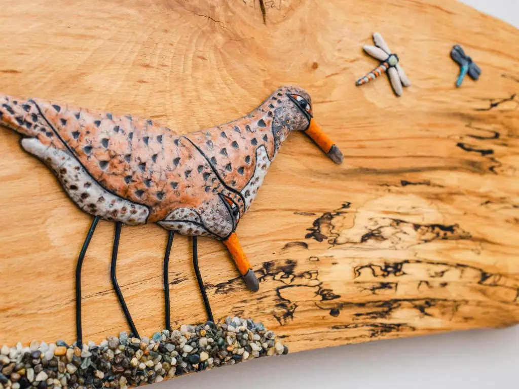 a wooden cutting board with a bird toy on it at Chalet Sandpiper Lodge by Interhome in Spean Bridge