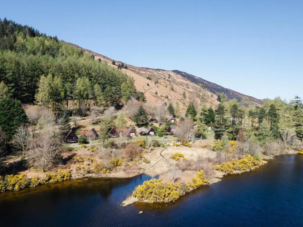 an island in the middle of a river with trees at Chalet Sandpiper Lodge by Interhome in Spean Bridge