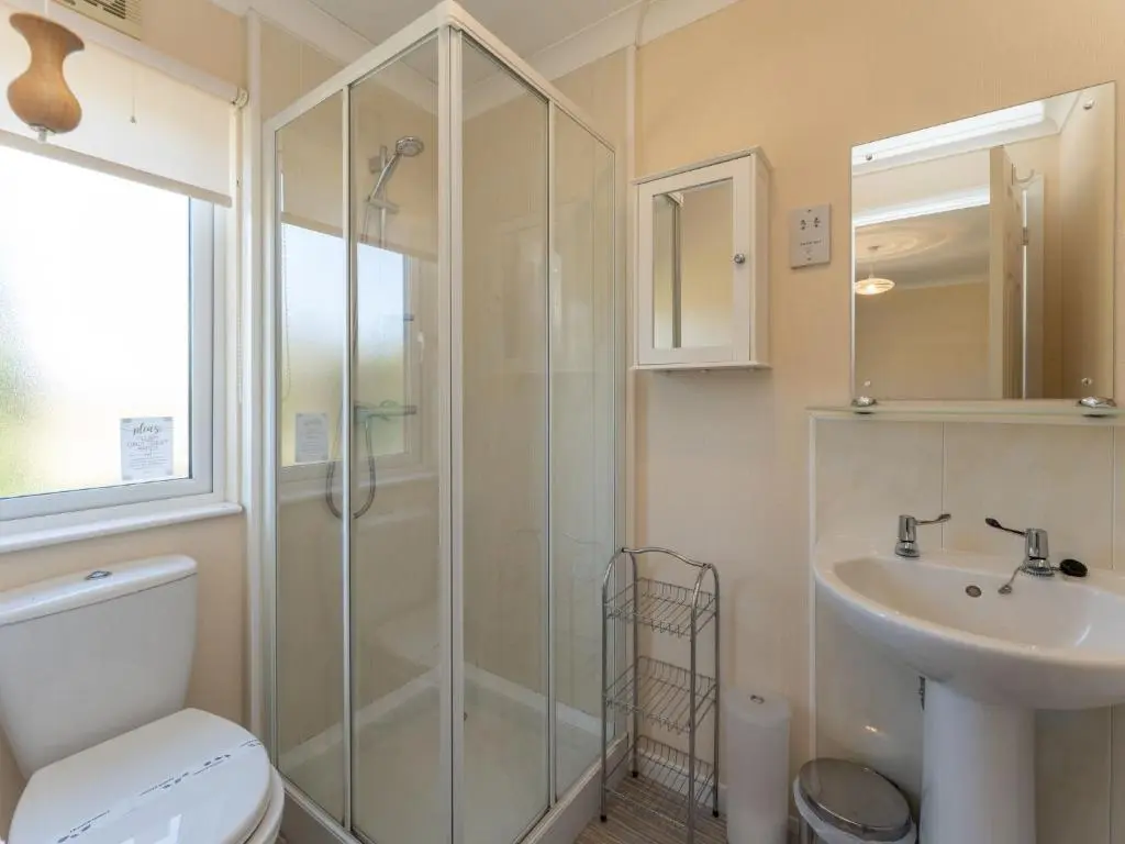 a bathroom with a shower and a toilet and a sink at Chalet Lodge 5 by Interhome in Boat of Garten