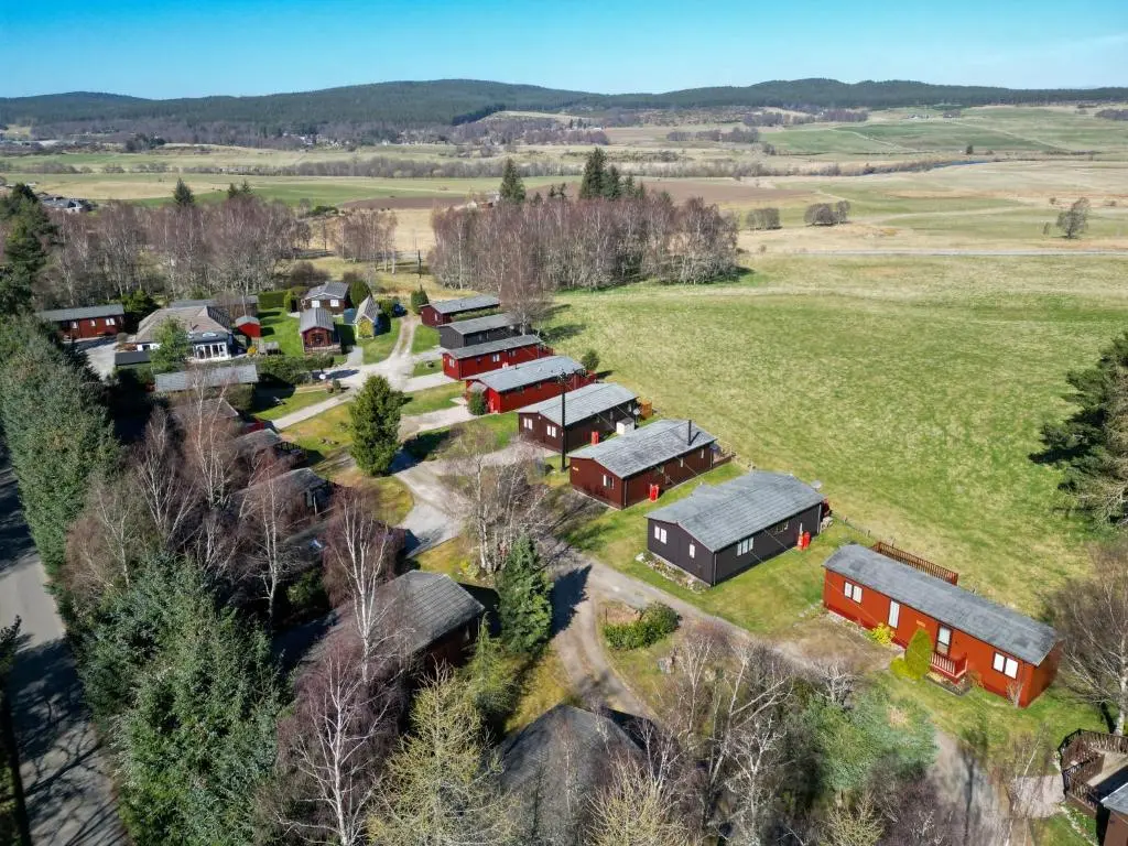 an aerial view of a farm with red buildings at Chalet Lodge 5 by Interhome in Boat of Garten