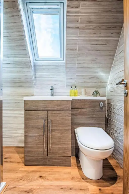 a bathroom with a toilet and a window at Chalet Oystercatcher by Interhome in Spean Bridge