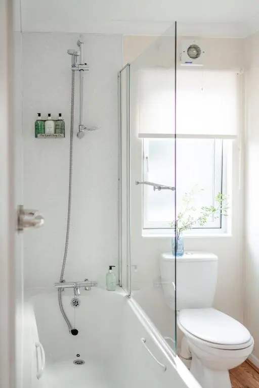 a bathroom with a tub and a toilet and a shower at Chalet Lodge 7 by Interhome in Boat of Garten