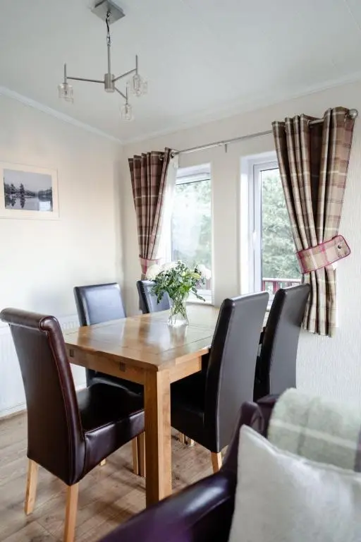 a dining room with a wooden table and chairs at Chalet Lodge 2 by Interhome in Boat of Garten