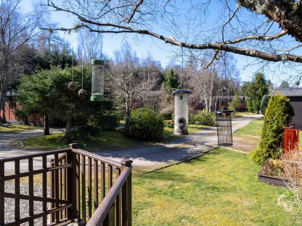 a yard with a wooden fence and a gate at Chalet Lodge 8 by Interhome in Boat of Garten