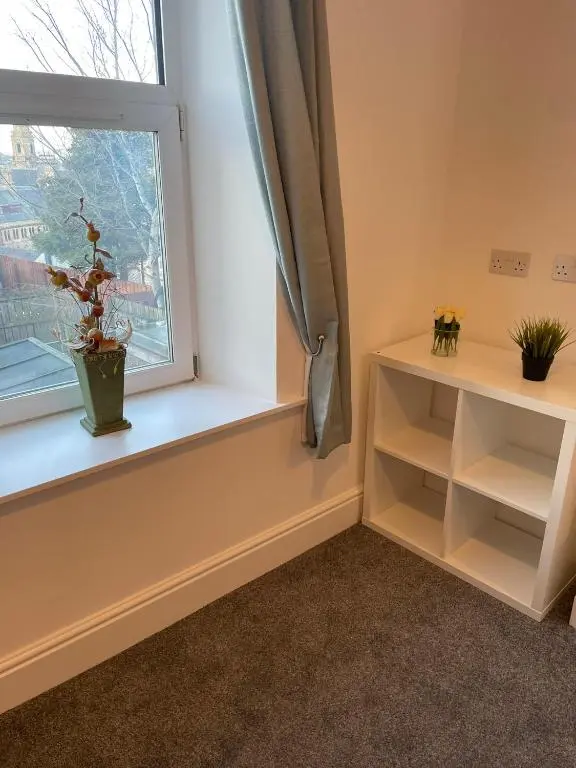 a room with a window with a potted plant on it at Tartan House in Inverness