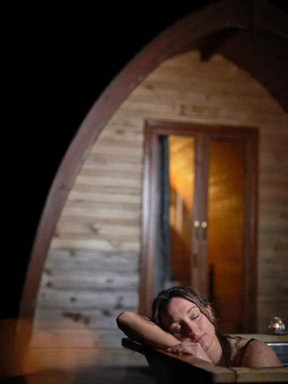 a woman sitting in a chair in front of a mirror at Glenshee Glamping in Glenshee