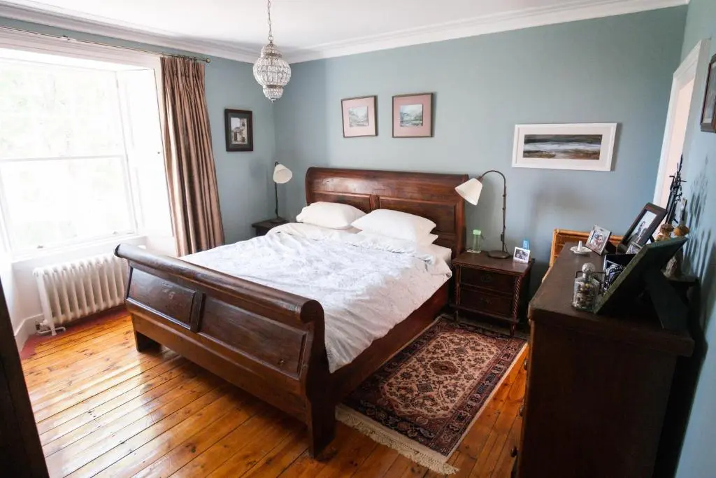 a bedroom with a large bed and a window at The Old Manse Oyne in Oyne