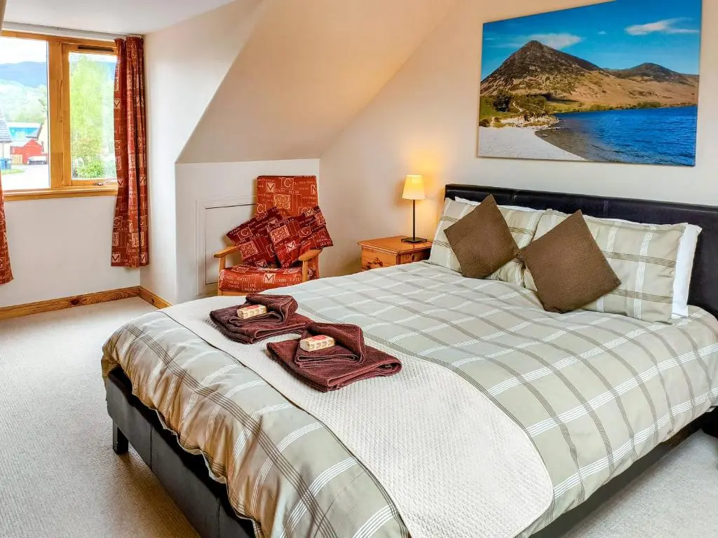 a bedroom with a bed with a tray on it at Rowlands in Aviemore