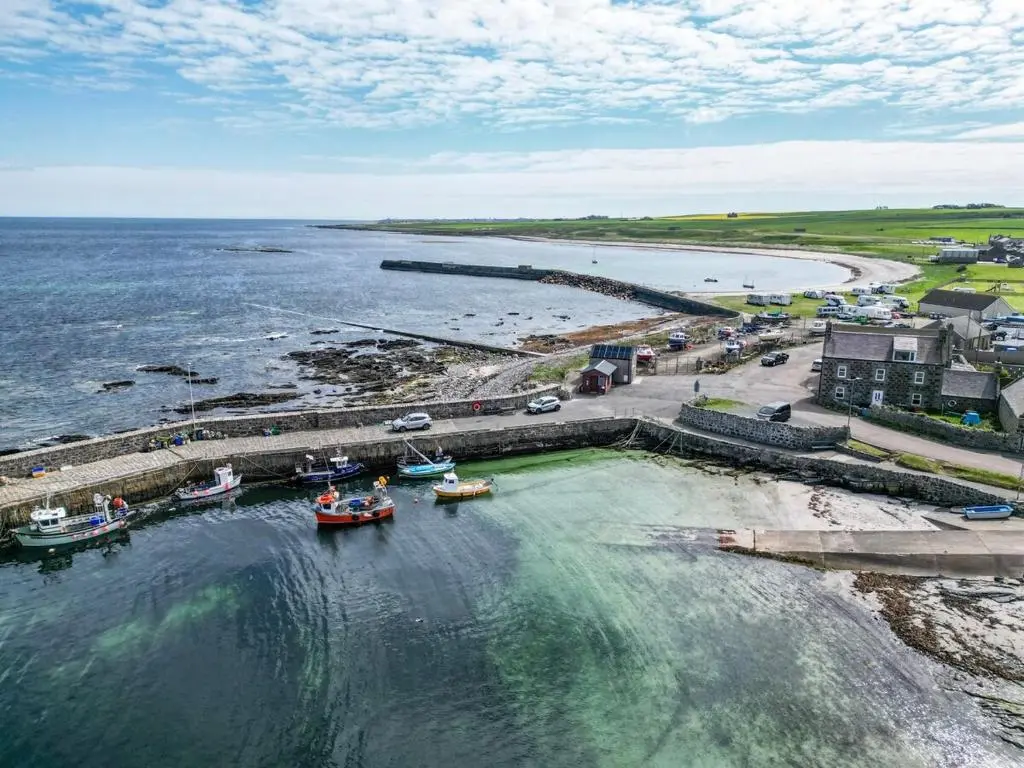 an aerial view of a beach with boats in the water at Rosehearty house - 3 bedroom in Rosehearty