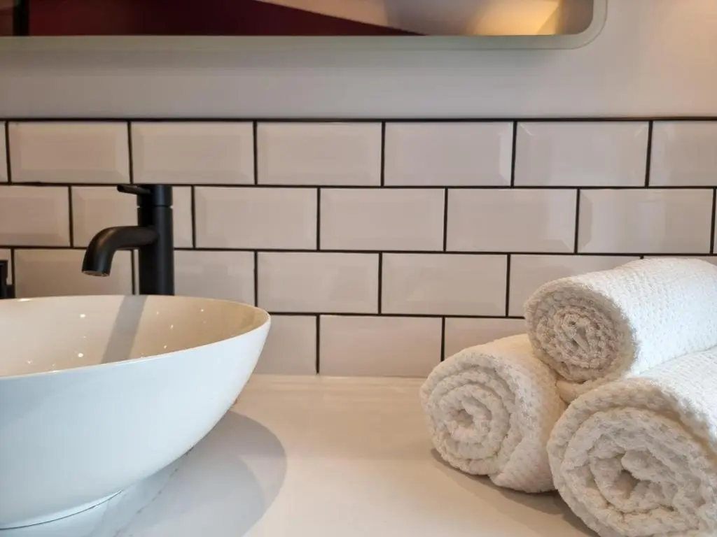 a bathroom with a sink and towels on a counter at West Lodge, High Street in Aberlour