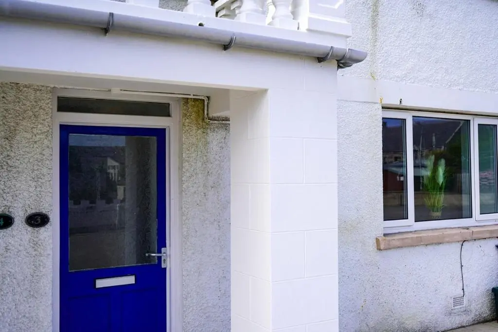 a blue door on the side of a building at Park House - 3 bedroom in Portsoy
