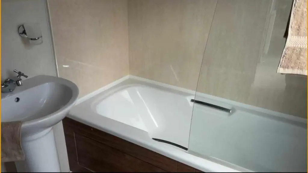 a bathroom with a white tub and a sink at Northern Light Villa, forest, beach and bubbles in Burghead