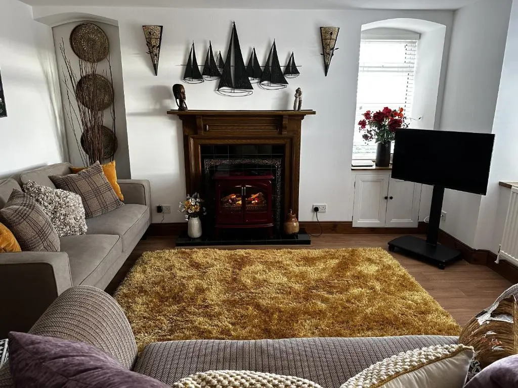 a living room with a couch and a fireplace at Sealladh Sona in Inverness