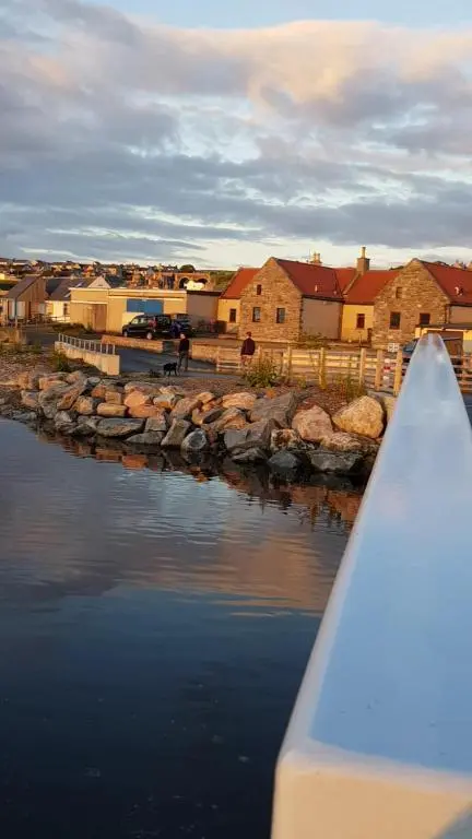 a view of a river with houses in the background at Idyllic beach cottage 56 Seatown Cullen in Cullen