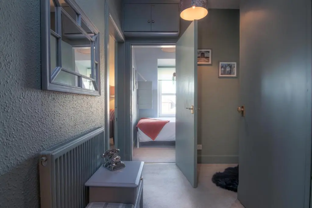 a hallway with a door leading to a bedroom at Laughlin House in Inverness