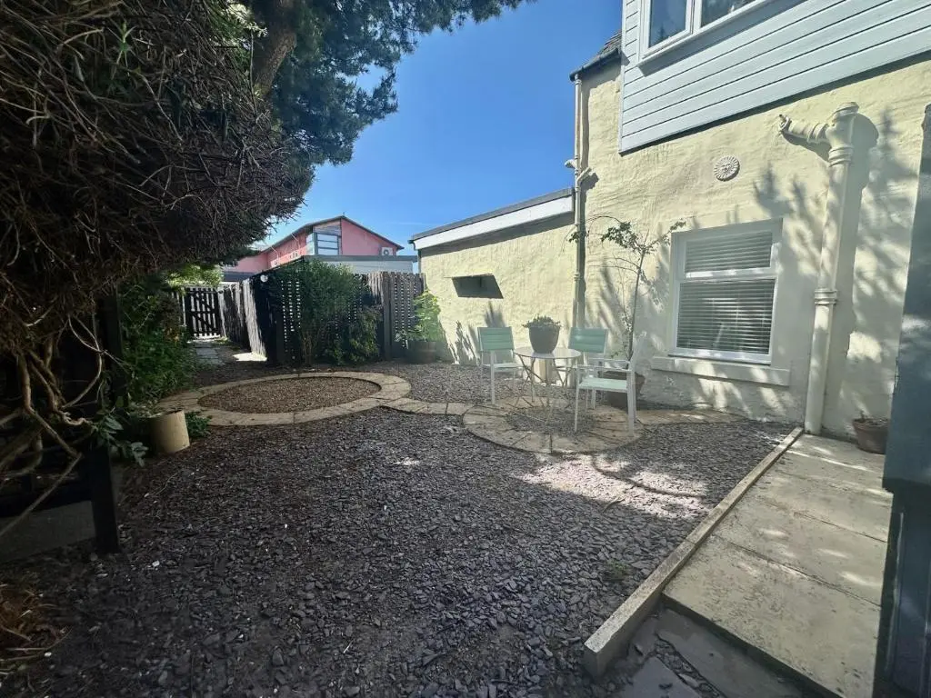 a backyard with two chairs and a table at Laughlin House in Inverness