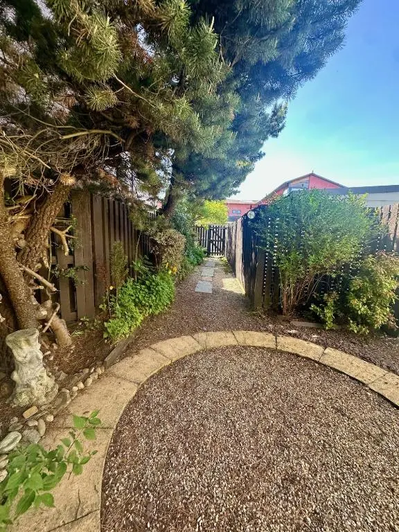 a garden with a circular walkway and a tree at Laughlin House in Inverness