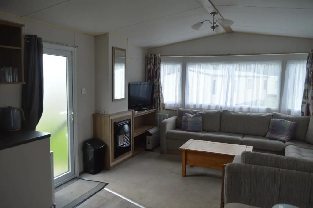 a living room with a couch and a tv at B5 at The Old Mill Holiday Park in Dyke