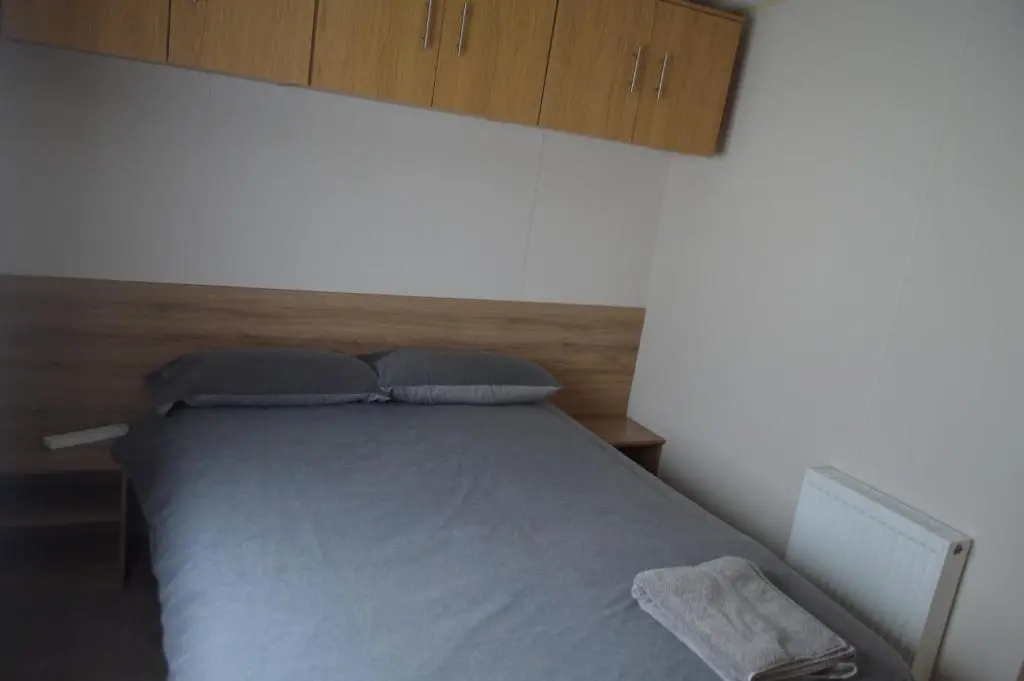 a bed with two pillows on it in a room at B5 at The Old Mill Holiday Park in Dyke