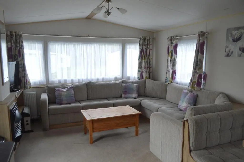 a living room with a couch and a coffee table at B5 at The Old Mill Holiday Park in Dyke