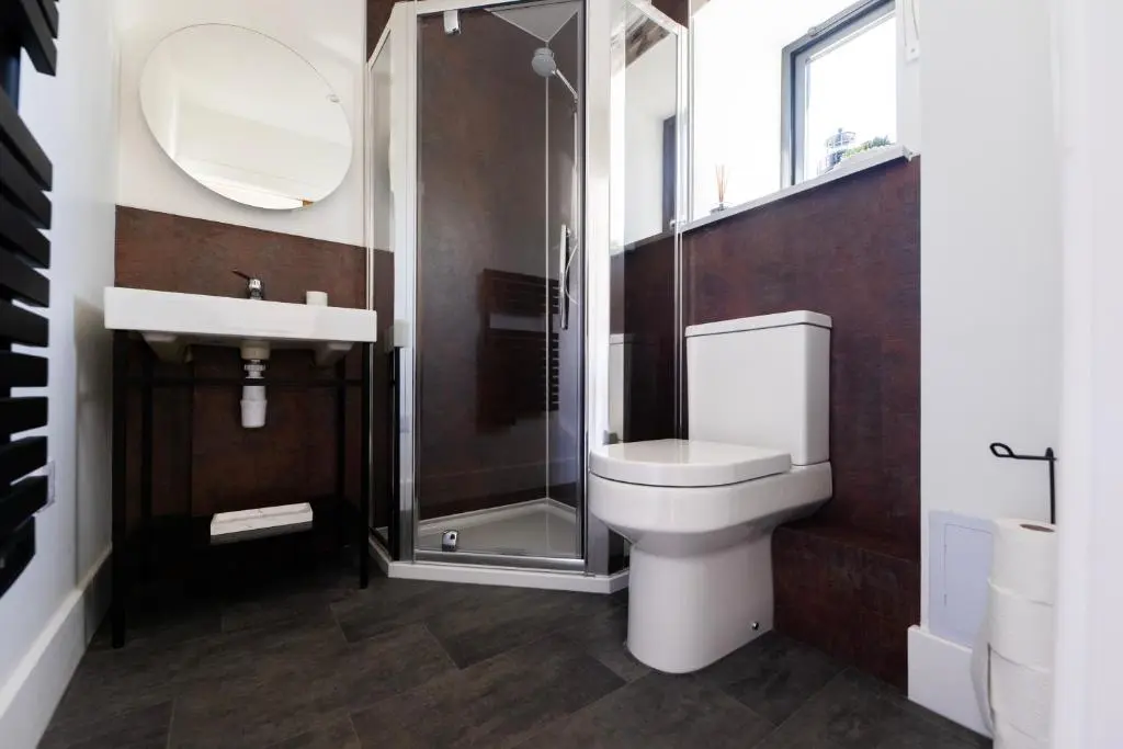 a bathroom with a toilet and a shower and a sink at Firthview Fortrose in Fortrose