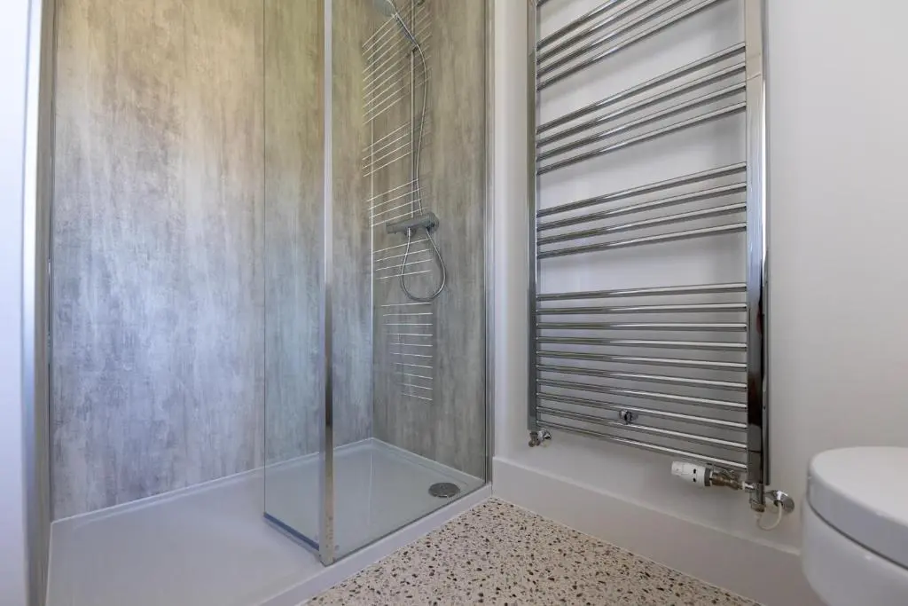 a shower with a glass door in a bathroom at Firthview Fortrose in Fortrose