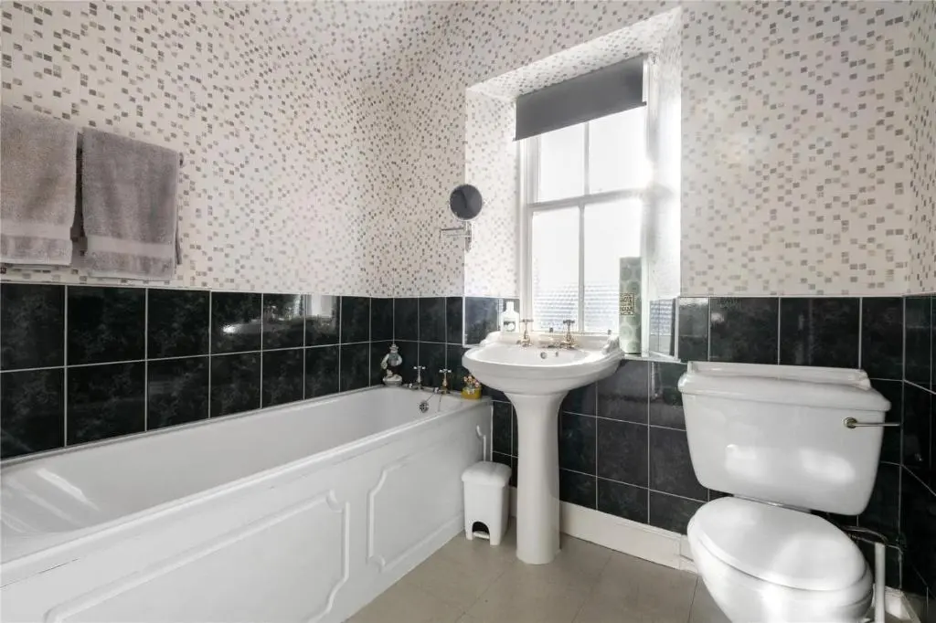 a bathroom with a tub and a sink and a toilet at Gruinard Guest House in Beauly