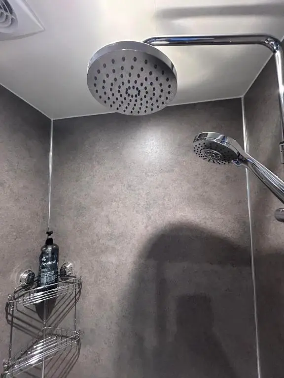 a shower with a shower head in a bathroom at Gruinard Guest House in Beauly