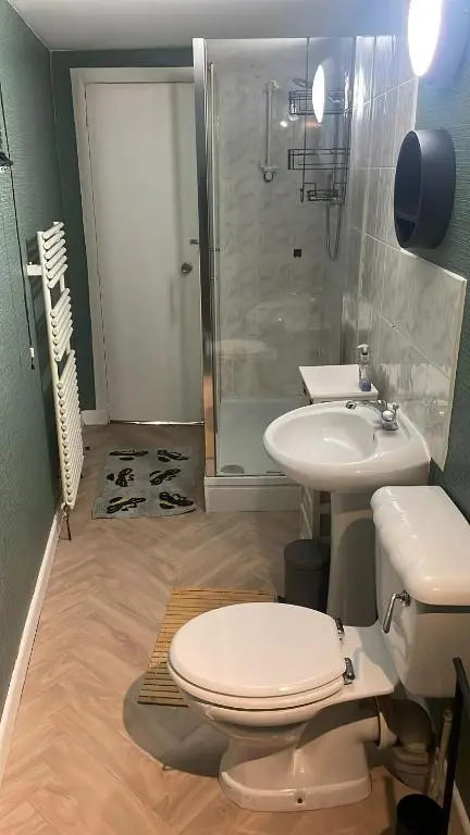 a bathroom with a toilet and a sink and a shower at Casale Peterculter in Peterculter