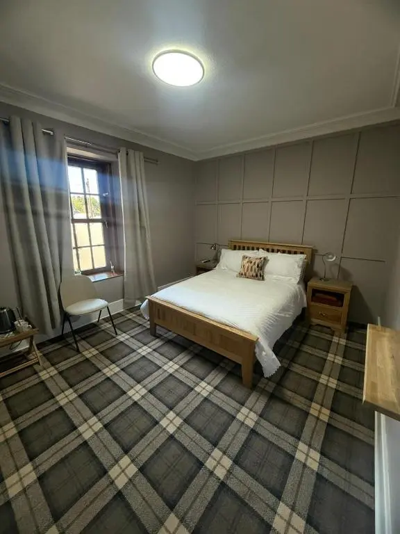a bedroom with a bed and a window at The Barrel in Ballater
