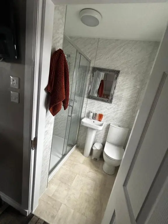 a bathroom with a shower and a toilet and a sink at The Barrel in Ballater