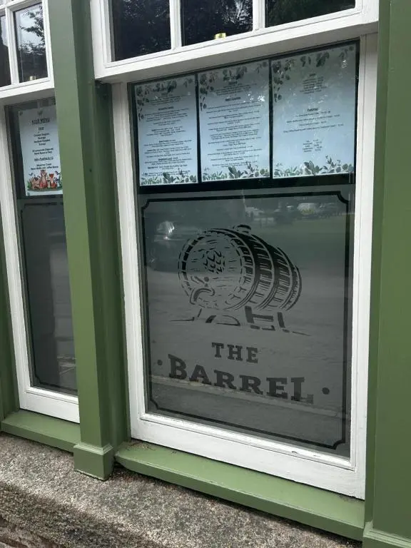 a sign in the window of a barber shop at The Barrel in Ballater