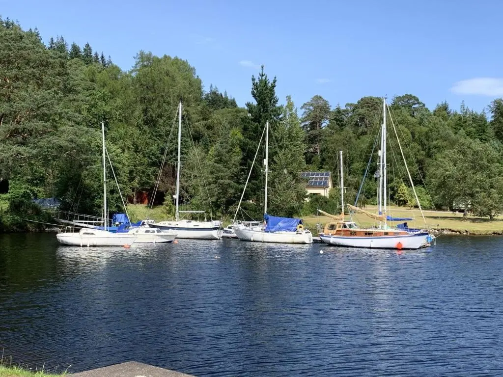 a group of boats sitting in the water at Chalet Heron Lodge by Interhome in Spean Bridge