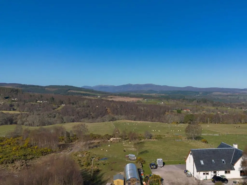 an aerial view of a farm with a barn and animals at Studio Crofters View by Interhome in Inverness