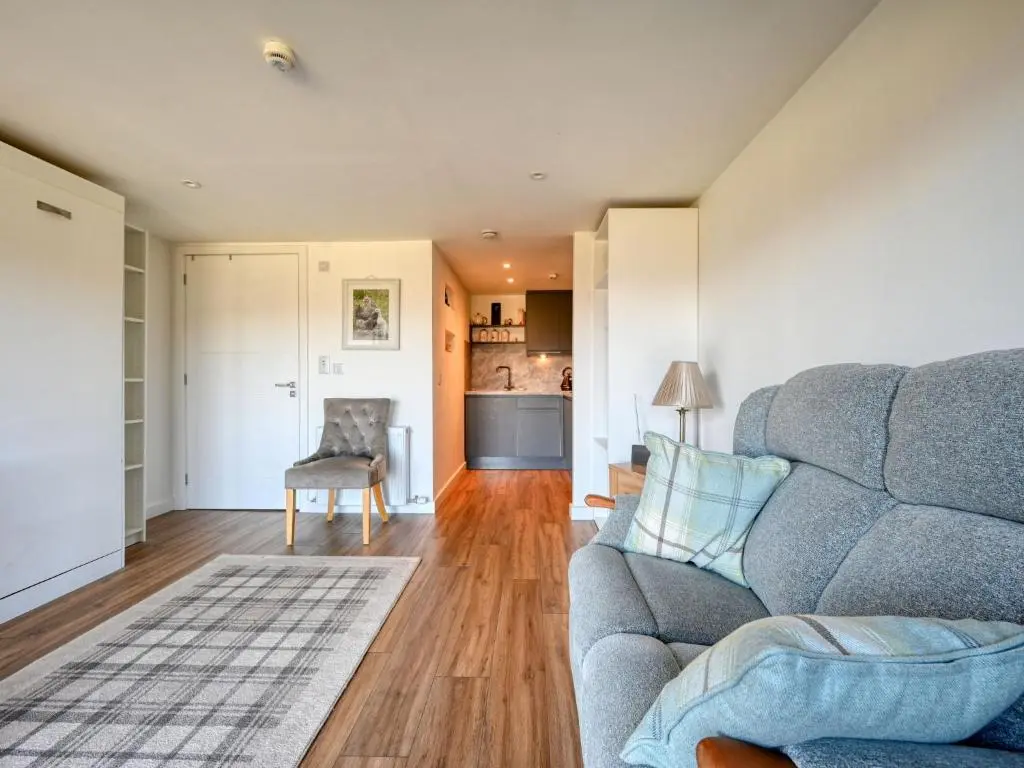 a living room with a couch and a chair at Studio Crofters View by Interhome in Inverness