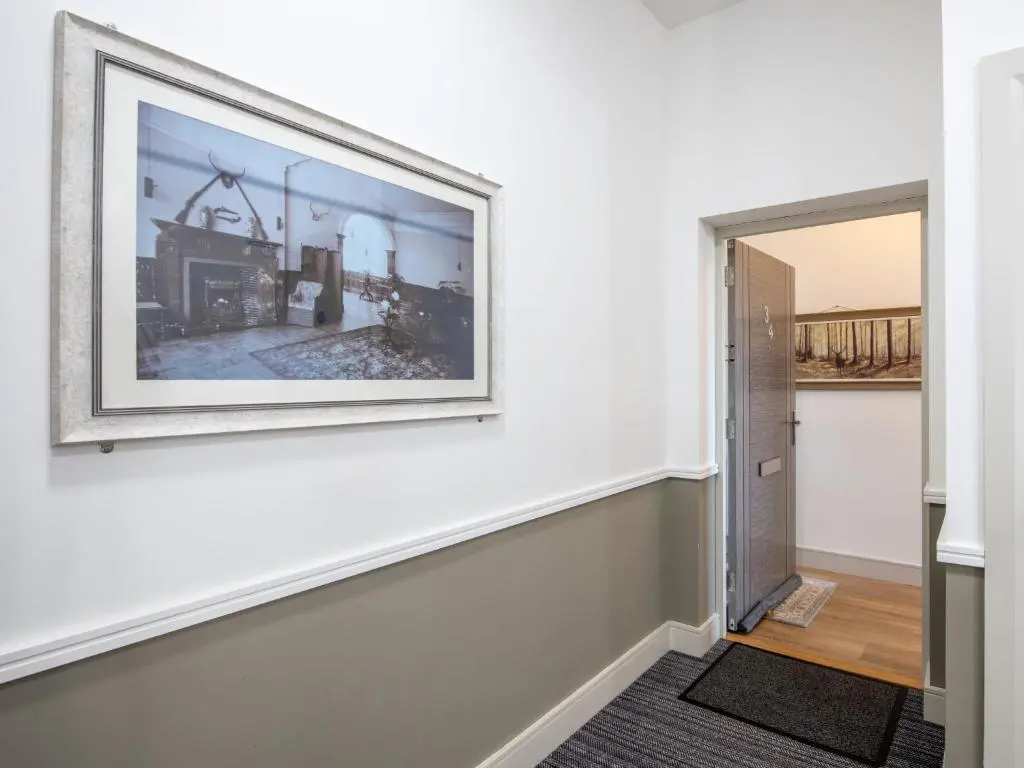 a picture hanging on a wall in a room with a hallway at Apartment Great Glen View by Interhome in Inverness