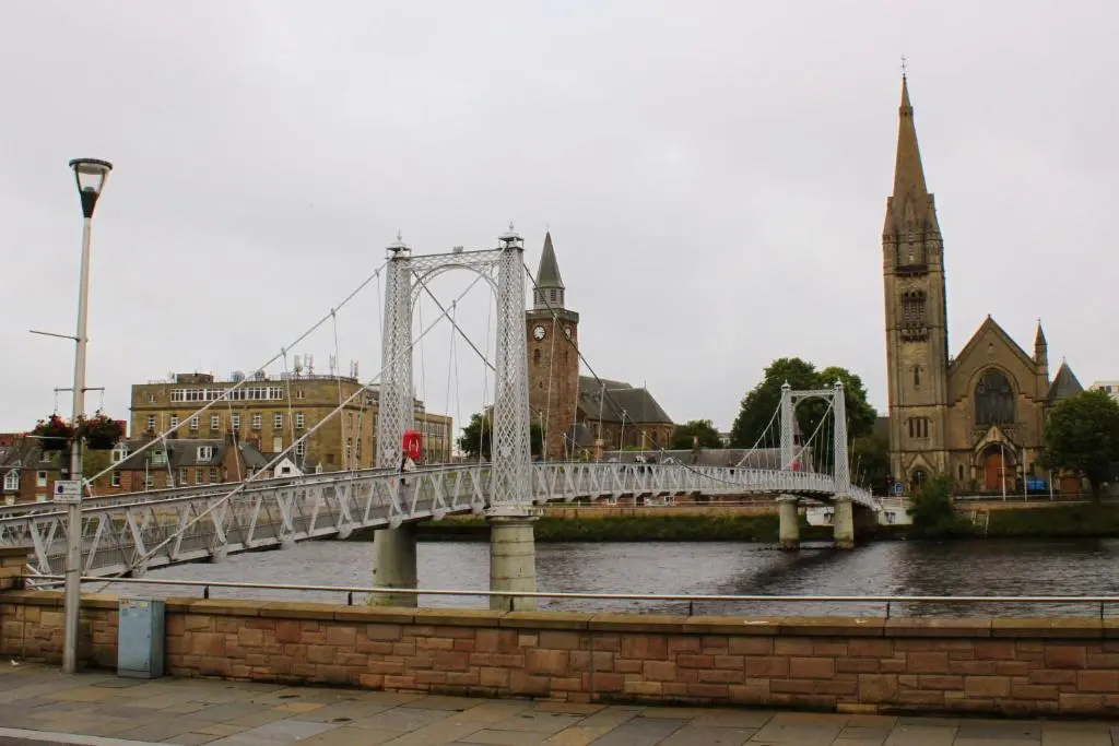 a bridge over a river in a city at Modern ground floor flat, Inverness city in Inverness