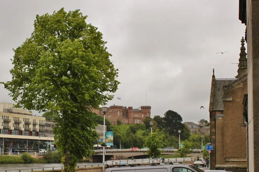 a white van parked next to a tree at Modern ground floor flat, Inverness city in Inverness