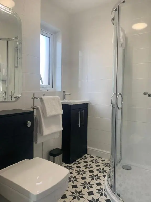 a bathroom with a shower and a toilet and a sink at Modern ground floor flat, Inverness city in Inverness