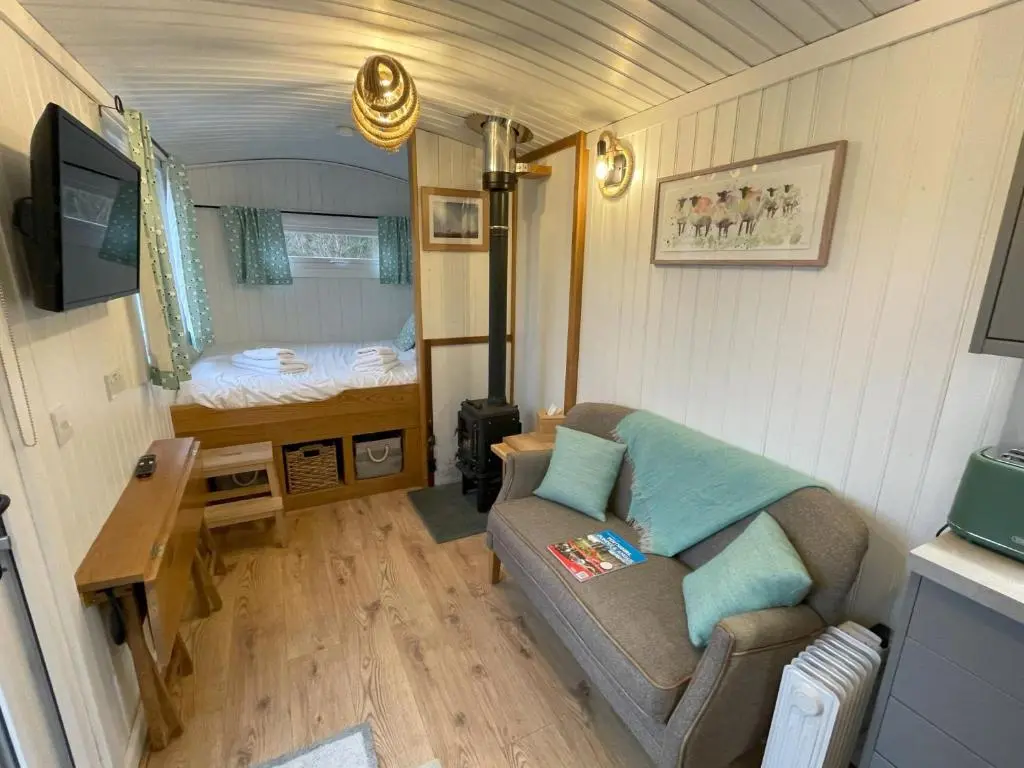 a small living room with a couch and a bed at Shepherds View in Glenshee