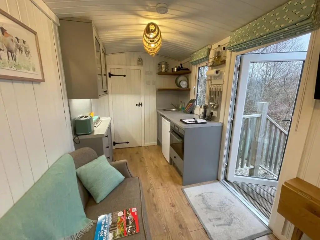 a tiny house with a kitchen and a living room at Shepherds View in Glenshee
