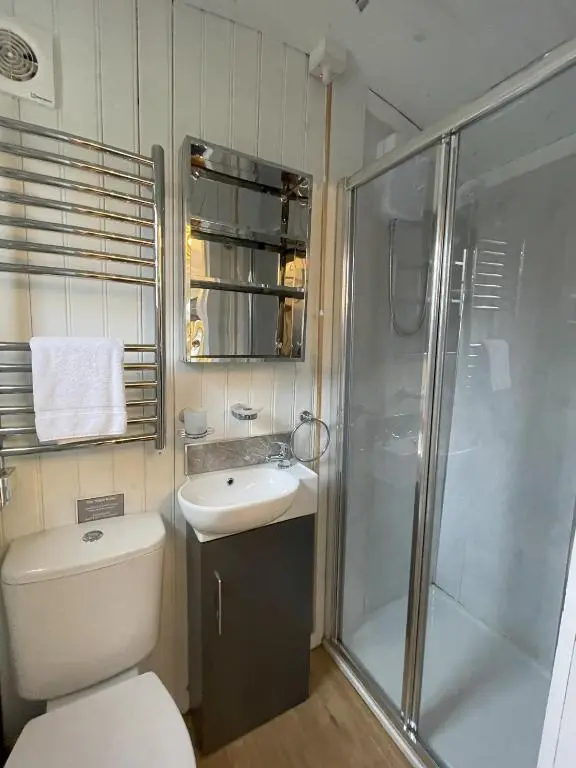 a bathroom with a shower and a toilet and a sink at Shepherds View in Glenshee