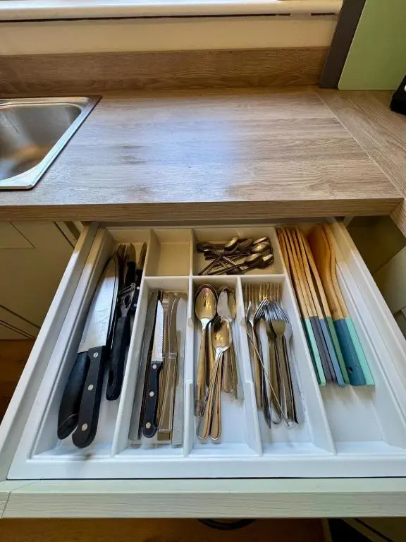 a drawer filled with utensils in a cabinet at The Ivy Nest, central in Inverness