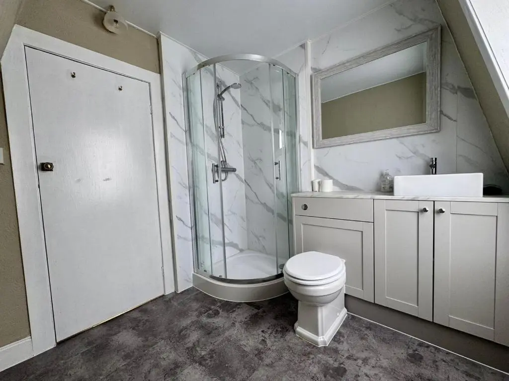 a bathroom with a shower and a toilet and a sink at The Ivy Nest, central in Inverness