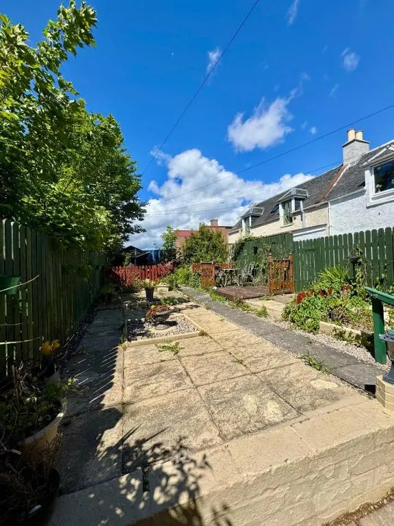 a pathway in a yard with a fence at The Ivy Nest, central in Inverness