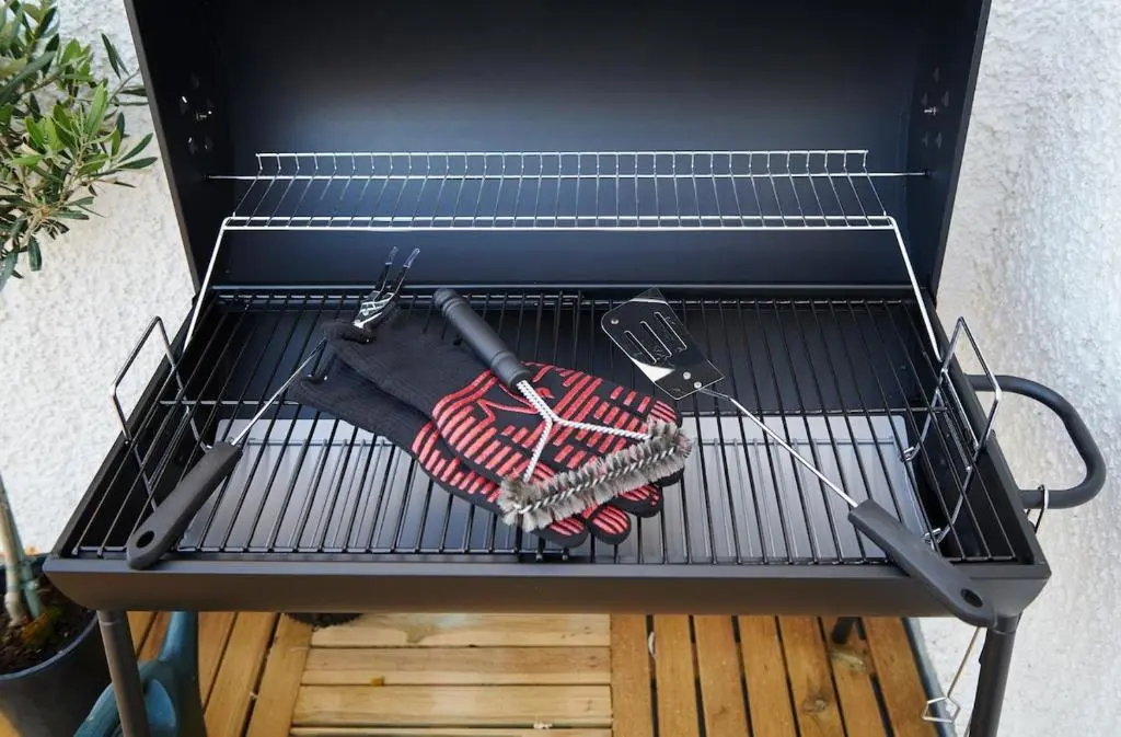 a grill with a spatula and tongs on it at The Sandpiper in Burghead